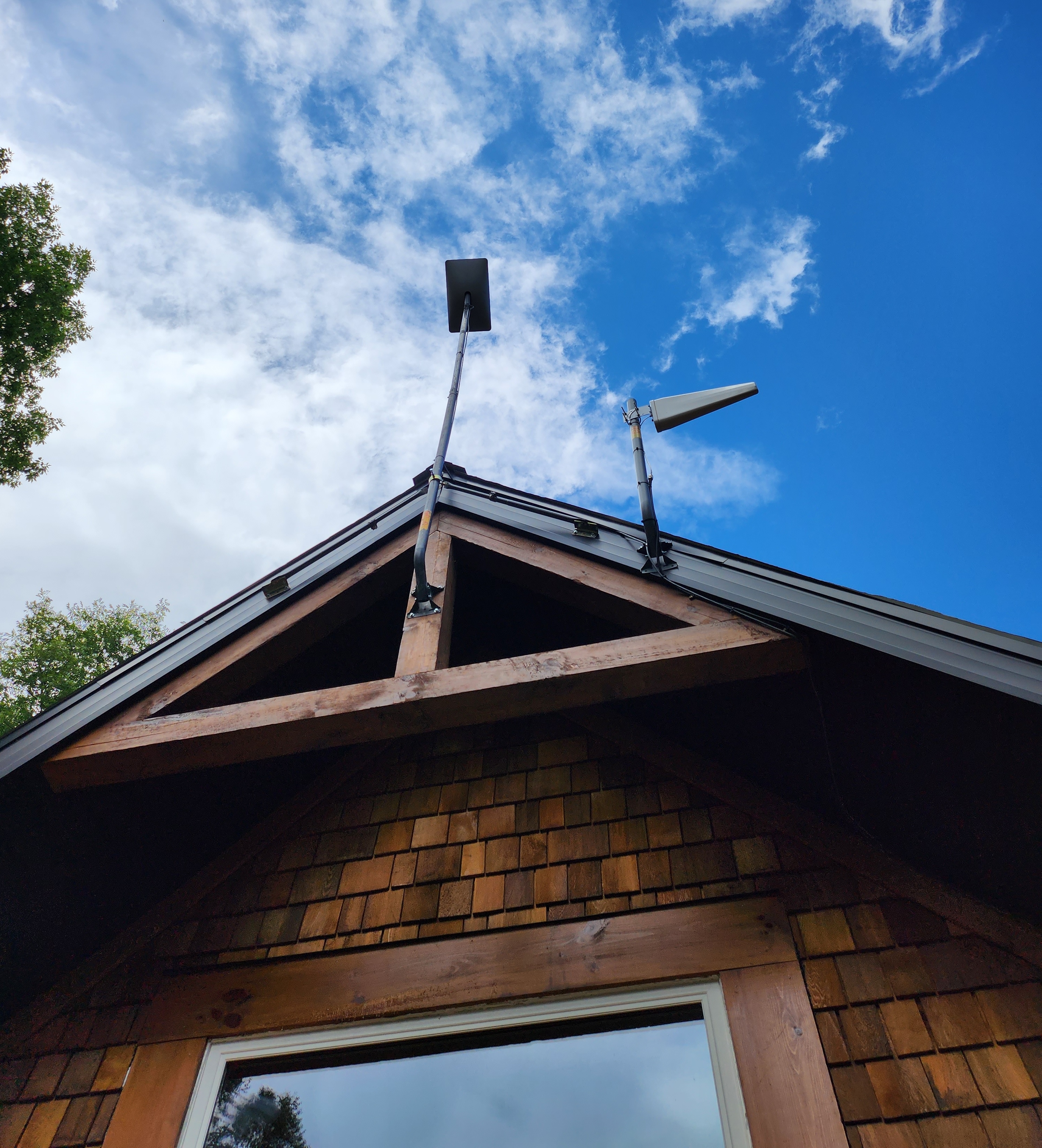 gen 2 starlink j-arm and cell extender attached to a cottage roof