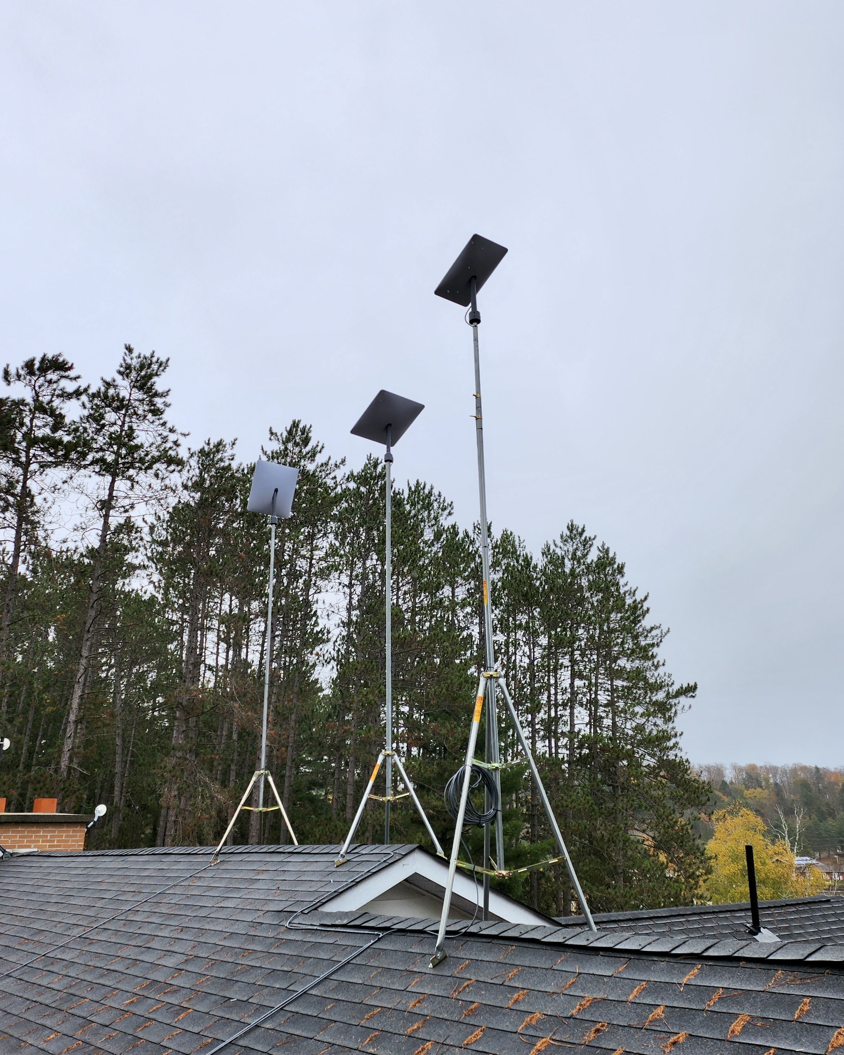 three starlink tripods installed on a roof 