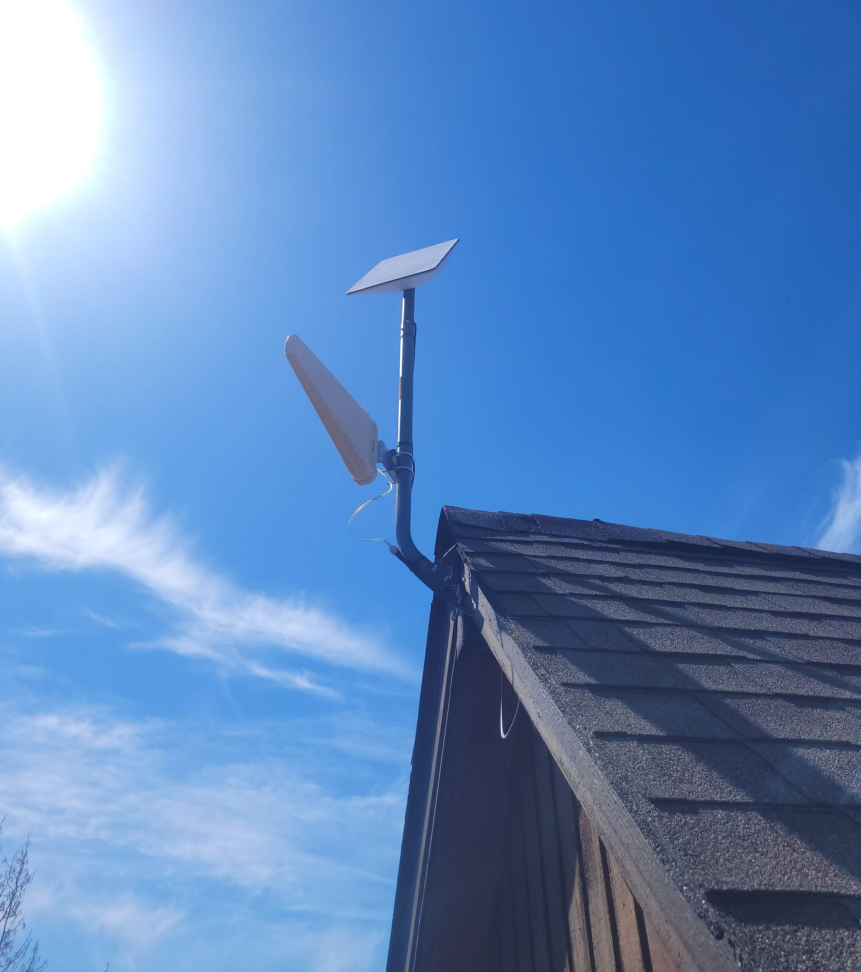 starlink and cell extender installed together on a rooftop j-arm